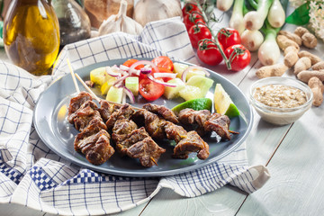 Traditional pork satay with peanut sauce and vegetables