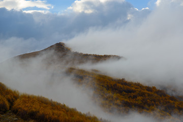 Autumn mountains covered with fog