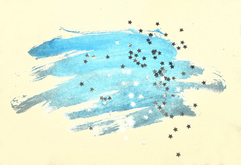 Silver glittering stars on abstract blue watercolor splash in vintage nostalgic colors.