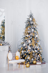 Gold Christmas tree with a gift in the living room
