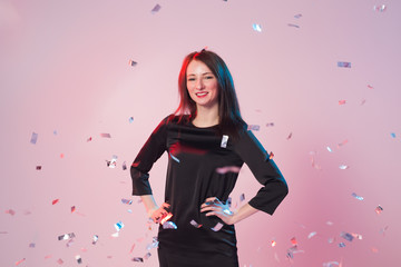 New Year, Saint Valentine's day and holidays concept - Cheerful young woman have fun while confetti...