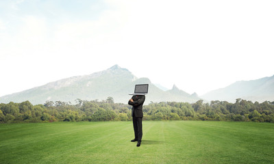 Businessman with laptop instead of head.