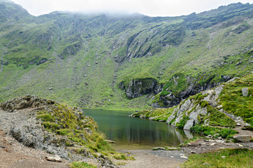 Fototapeta na wymiar The glacier lake called Balea (Balea Lac) on the Transfagarasan road from Fagaras mountains