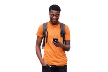 smiling young african american man looking at cellphone against isolated white background