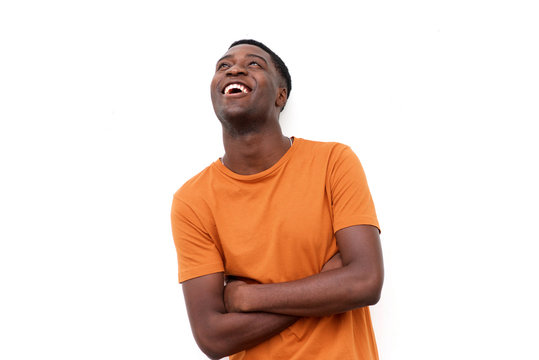 happy young black man laughing and looking up
