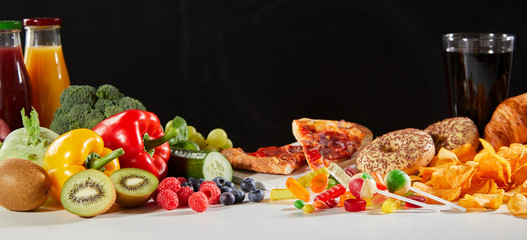 Fresh fruits and vegetables next to fast food