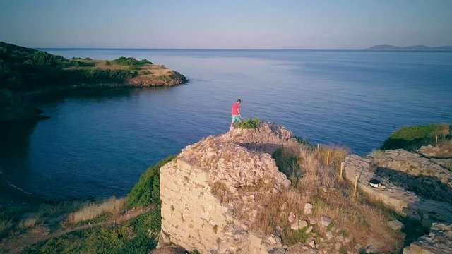 Man on castle ruins aerial shot, Sithonia, Greece
