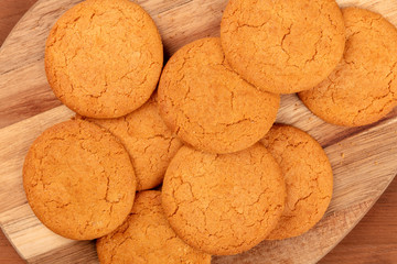 A closeup overhead photo of ginger cookies on rustic textures