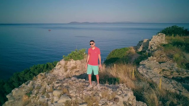 Man on castle ruins aerial shot, Sithonia, Greece