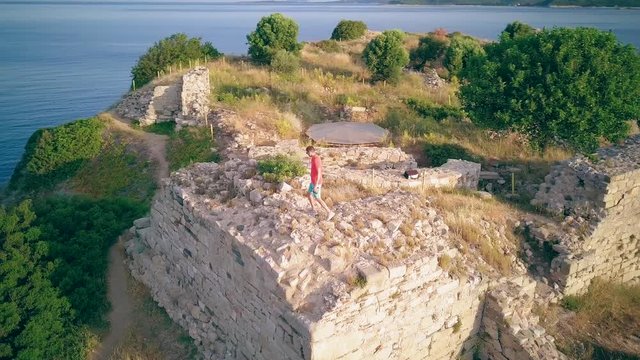 Man on castle ruins aerial shot, Sithonia, Greece