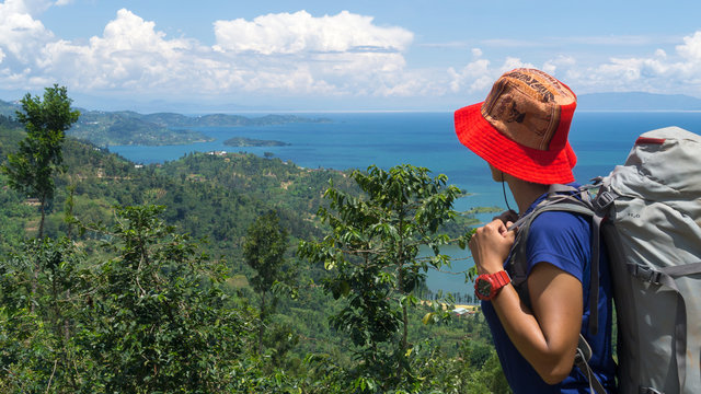 Woman Hiker Looking The Kivu Lake In Rwanda. View Of The Landscape In Rwanda With Woman