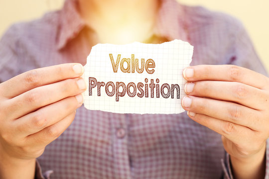 business woman holding tear paper with value proposition text