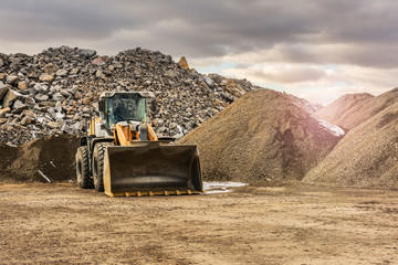 Quarry aggregate with heavy duty machinery. Construction industry. - obrazy, fototapety, plakaty