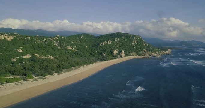 Aerial view of beautiful tropical desert island beach from drone. Stock footage of landscape paradise tropical island beach with blue color ocean water, wave, sea surface. Top view and amazing nature