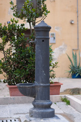Street well for potable water on street of small town in Southern Italy
