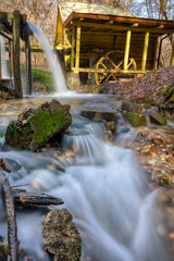 A stream of flowing clean spring water in an old mill. Photo taken in autumn in Russia.