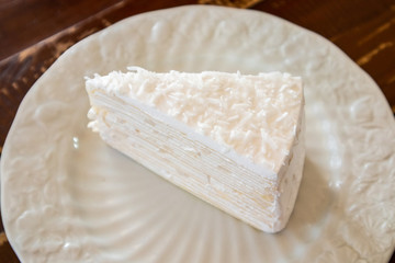 Coconut Crepe cake on wood table
