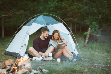 Young man and woman looking for direction on digital tablet 