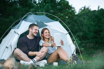 Young man and woman looking for direction on digital tablet 