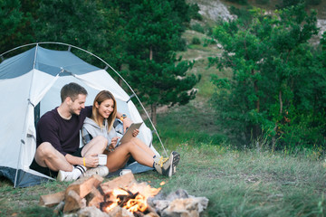 Young man and woman looking for direction on digital tablet 