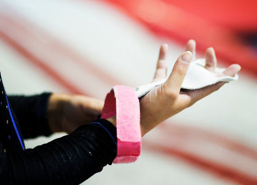 Young Gymnast Wearing A Grip Bar To Her Palm