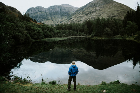 Man standing by the riverside in the Highlands