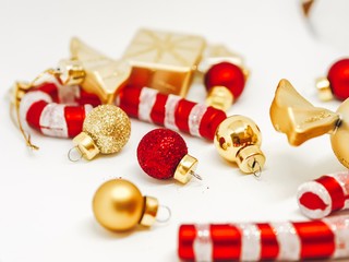 Christmas holiday decorations - beads and Christmas toys, balls, candy canes scattered on a wooden...