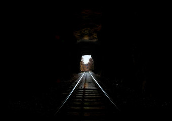 Railroad Tunnel into daylight long distance copy space light at end of tunnel