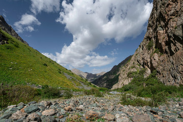 Walking between the mountains on a sunny day in Kyrgyzstan