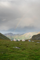 Yurt camp and rainbow in the Tien Shan mountains in Kyrgyzstan