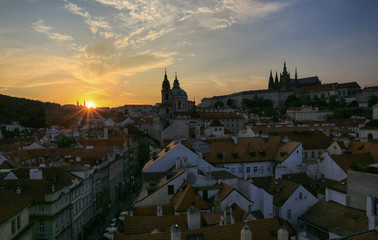 Fototapeta premium Prague, Czech Republic, September 19, 2018. Beautiful view from above on the city, red roofs of houses, Prague Castle and church in Mala Strana at sunset