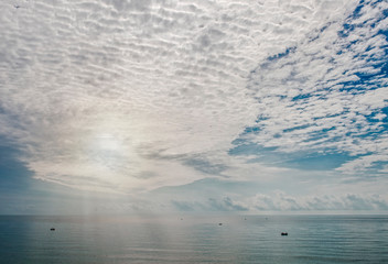 fishing boats far into the sea under the sky