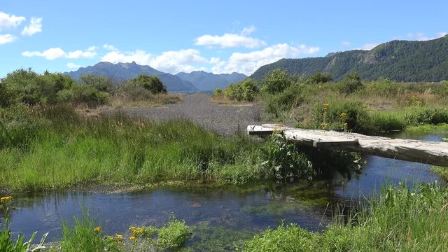 Wooden bridge over the creek near Tromen Lake. Lanin NP, Patagonia, Neuquen, Argentina