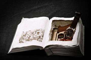 Wristwatch and gun in book safe
