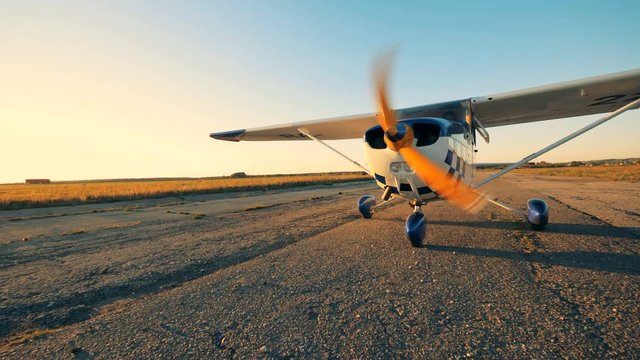 Small plane taking off a ground, close up.