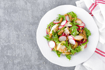 Light spring vegetable salad with radish, lettuce, arugula and chicken meat