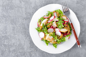 Light spring vegetable salad with radish, lettuce, arugula and chicken meat