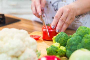 Cutting tomato with a knife.