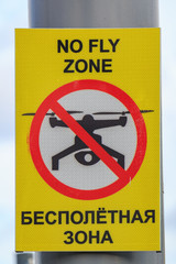 No fly zone sign prohibiting drone flights. Inscriptions in English and Russian languages