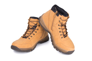 Two brown leather hiking boots or shoes isolated on white background.