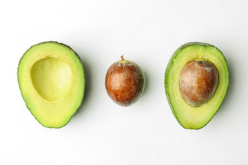 Composition with cut avocado on white background