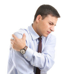 Young businessman suffering from pain in shoulder on white background