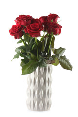 Beautiful bouquet of red roses in ceramic vase on white background