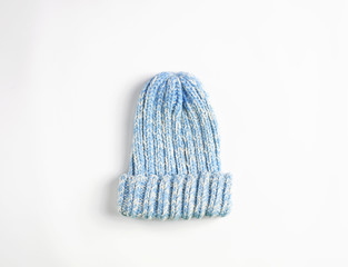 Light Blue knitted wool hat isolated on white background. Cold winter ski cap flat lay. woolen garment concept.