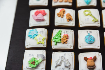 Homemade gingerbread christmas cookies advent calendar on black background