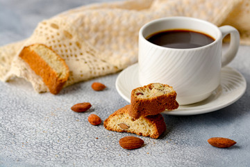 Good morning concept - breakfast frothy espresso coffee accompanied by delicious Italian almond cantuccini biscuits