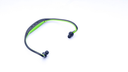 Wireless headphones closeup on white background with selective focus and crop fragme