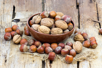 nuts in a bowl on old wooden background