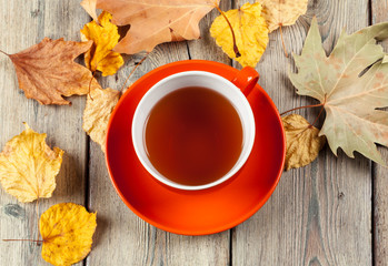 Naklejka na ściany i meble Cup of tea and autumn leaves on the table