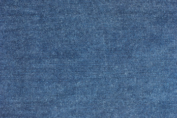 Old blue denim jeans texture or background with visible fibers